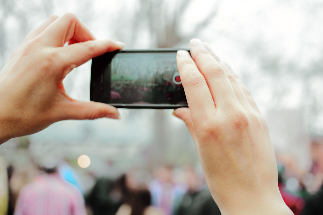 Woman shoots video on a smartphone